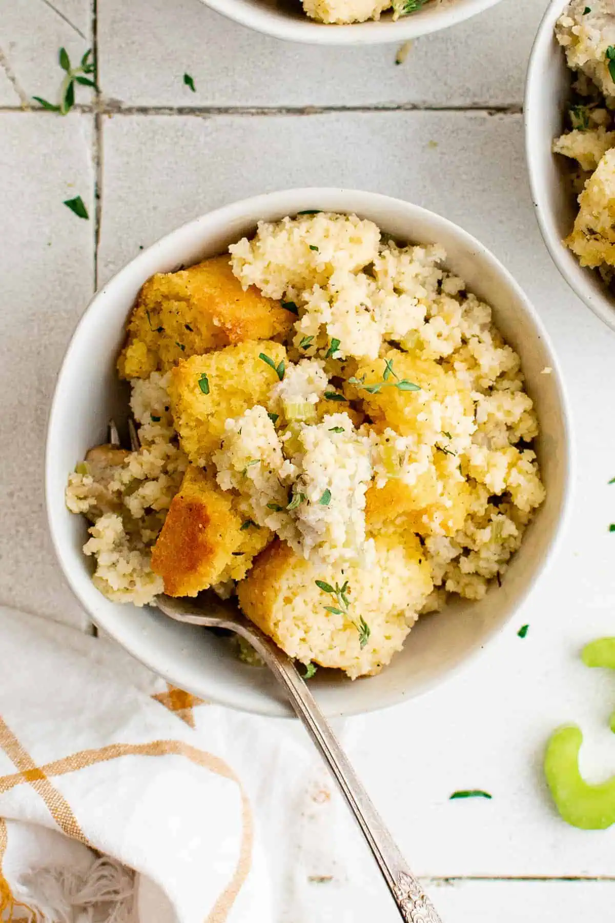 Top down view of cornbread stuffing in a white bowl.