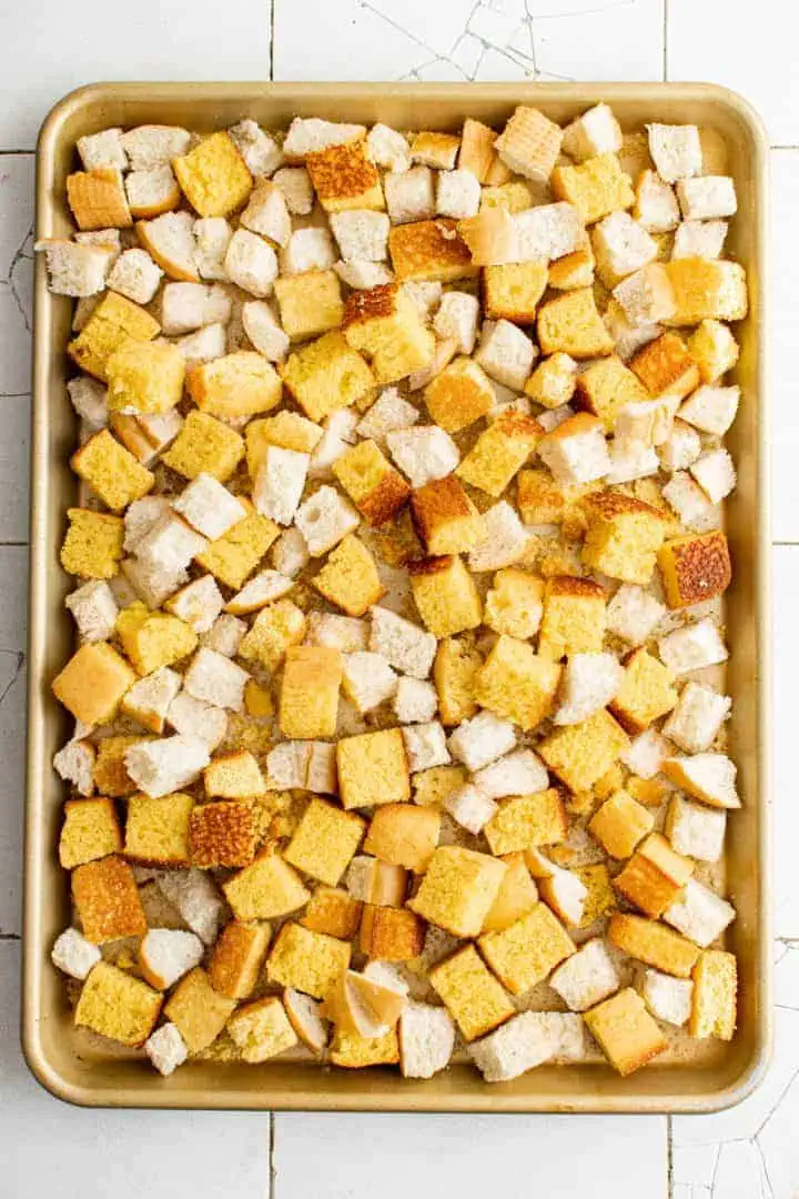 Southern Cornbread Dressing Recipe Top down view of a pan of toasted cornbread and bread pieces.