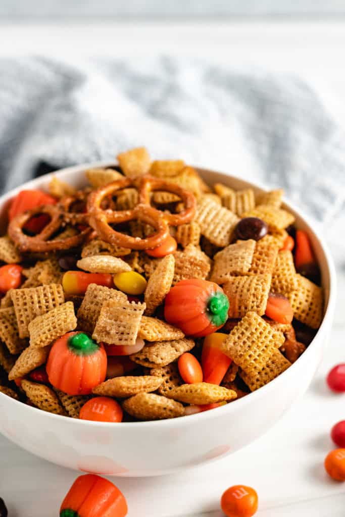 White bowl filled with snack mix and candy.