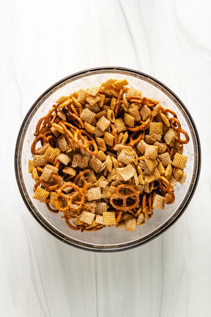 Top down view of cereal and pretzels tossed with brown sugar butter.