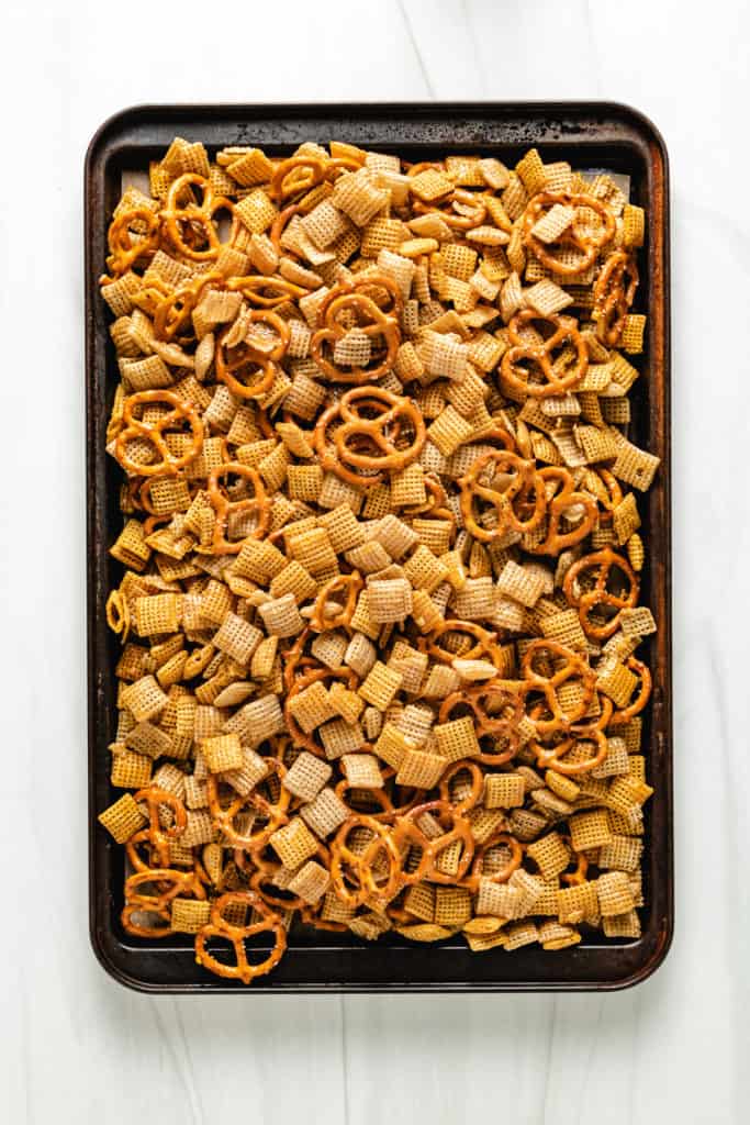 Top down view of baked snack mix on a sheet pan.
