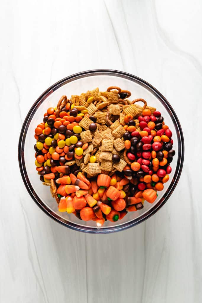 Top down view of various candy types on top of snack mix.