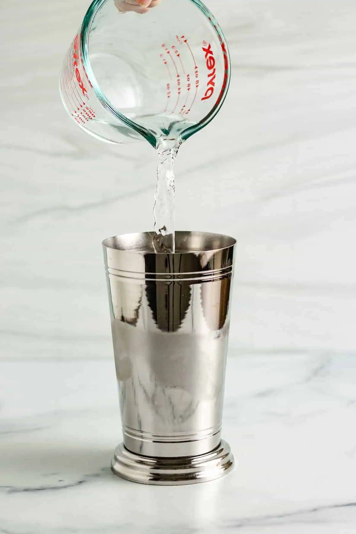 Rum being poured into a shaker.