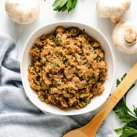 Top down view of rice with mushrooms and garlic.