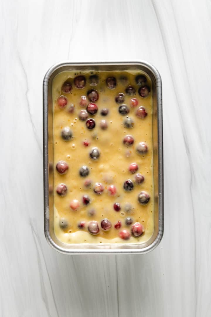 Best Orange Cranberry Bread Top down view of unbaked bread batter in a pan.