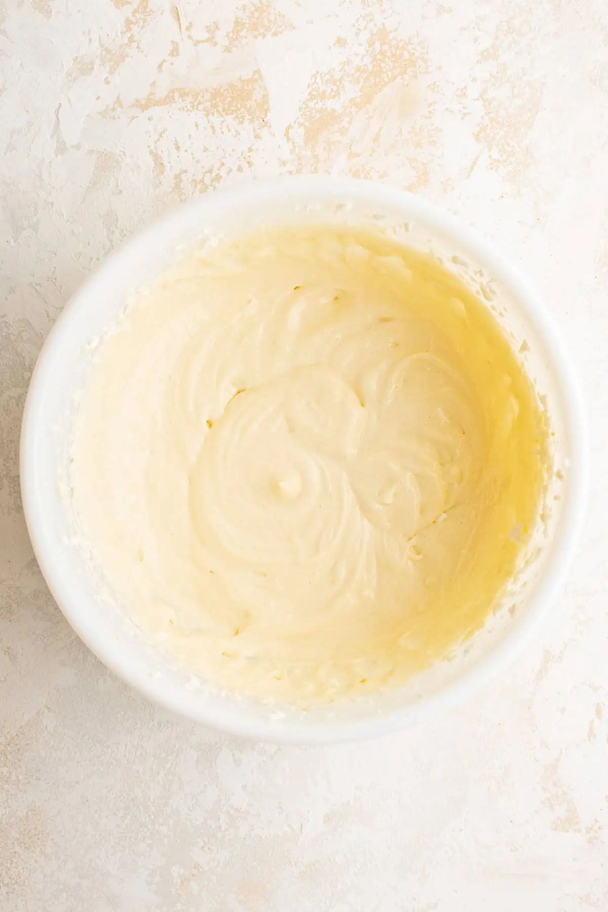 Top down view of cream cheese filling in a bowl.