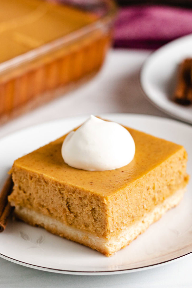 Pumpkin cheesecake bar on a white dish.