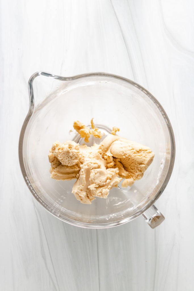 Top down view of shortbread dough in a bowl.