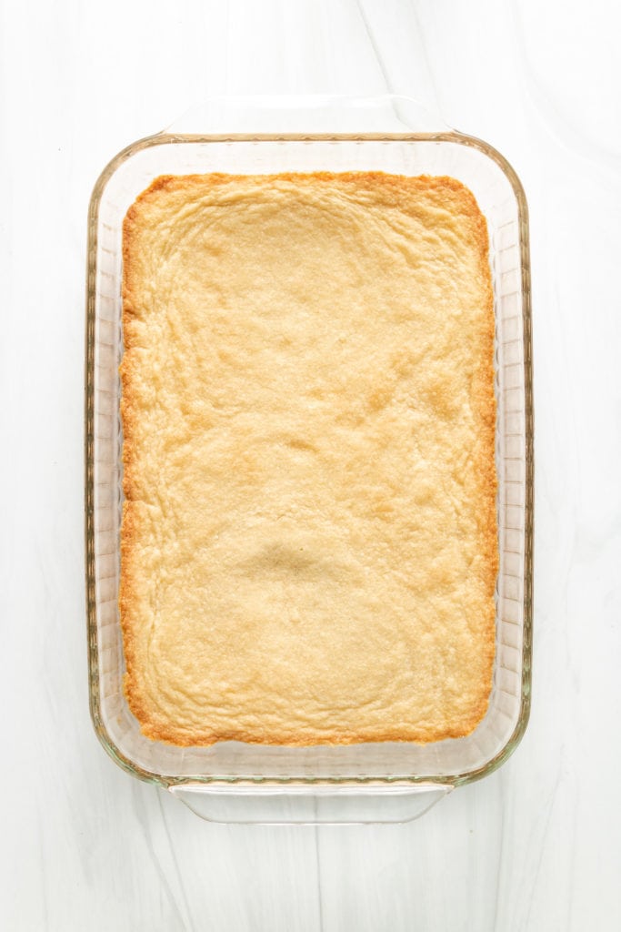 Top down view of shortbread crust in a baking dish.