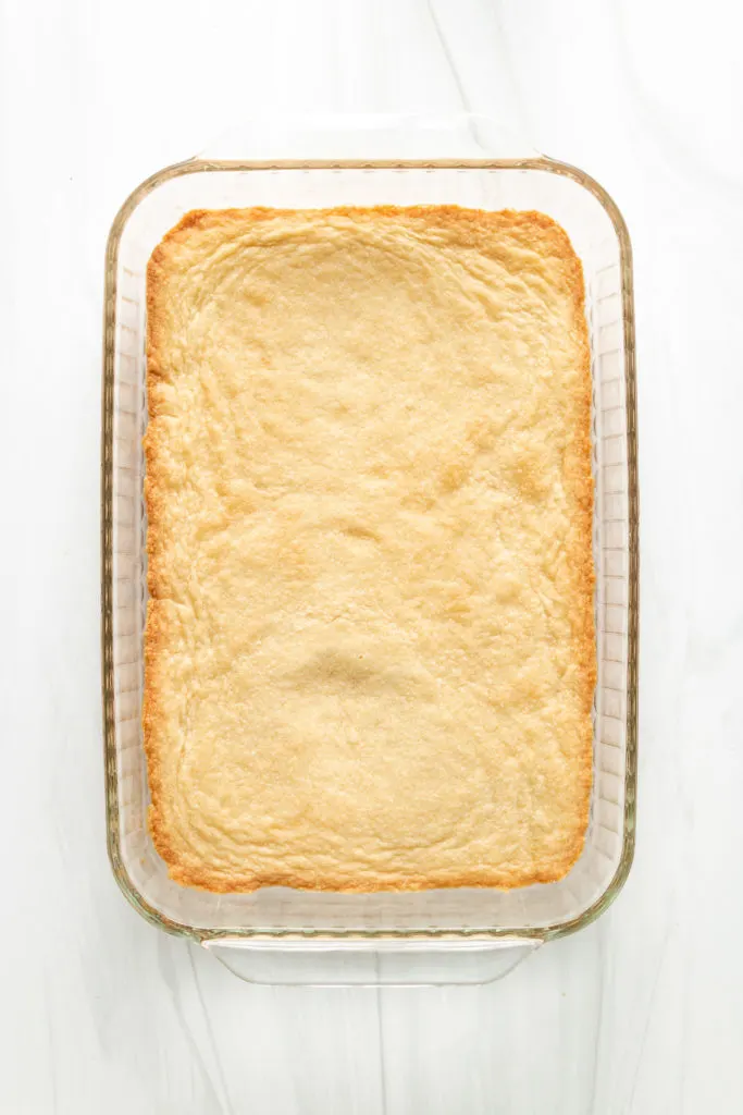 Top down view of shortbread crust in a baking dish.