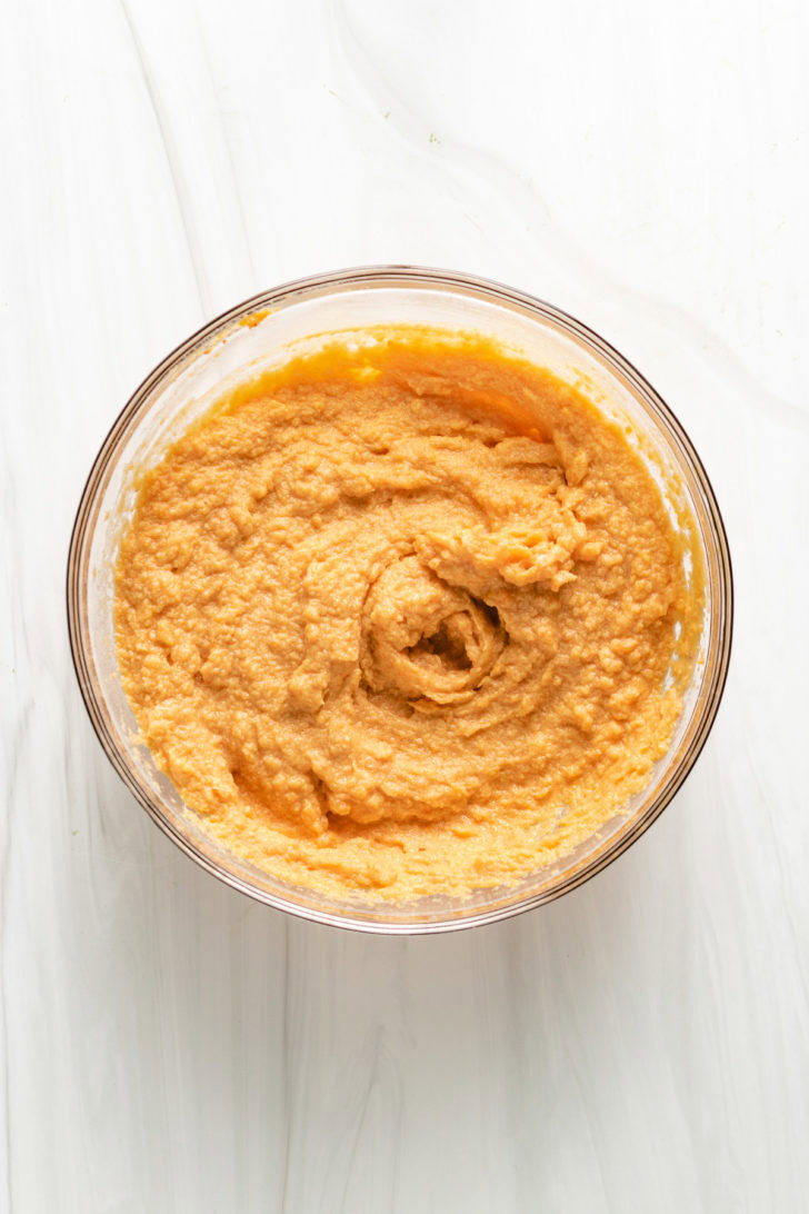 Sweet potato casserole filling in a glass bowl.