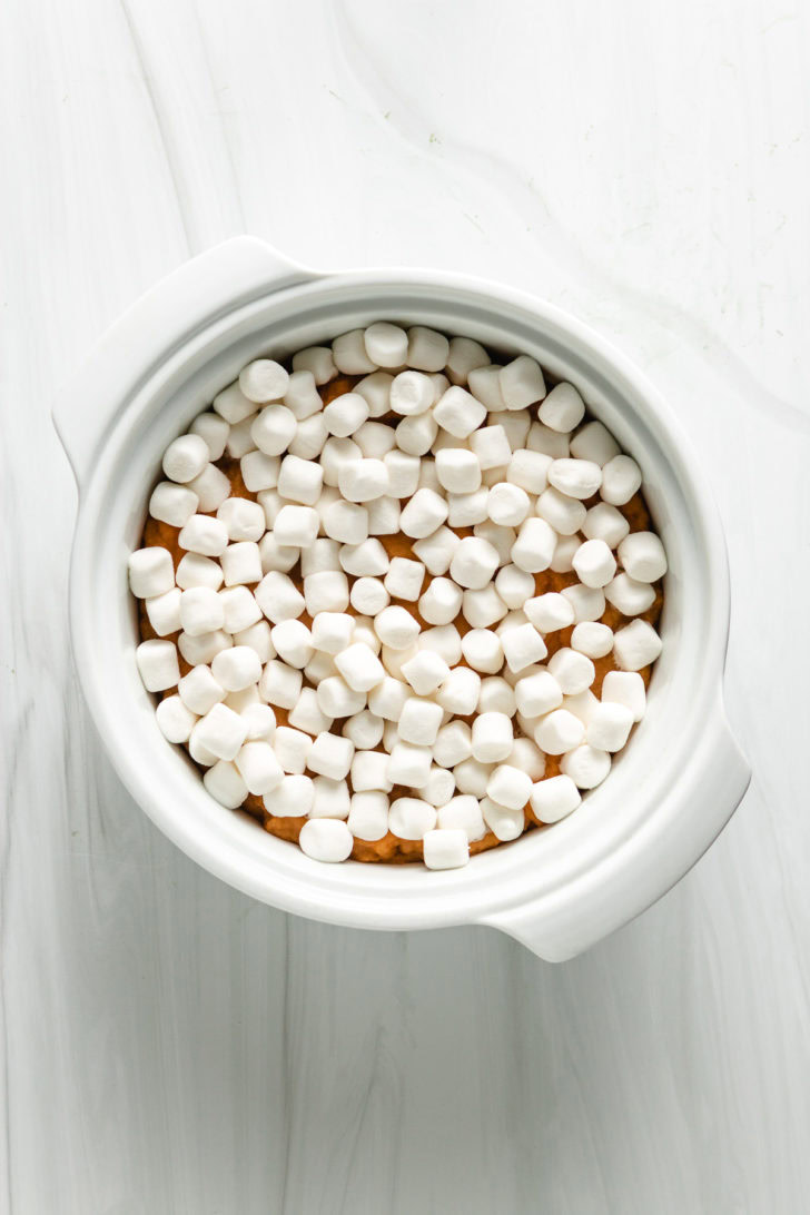Top down view of unbaked sweet potato casserole topped with marshmallows.
