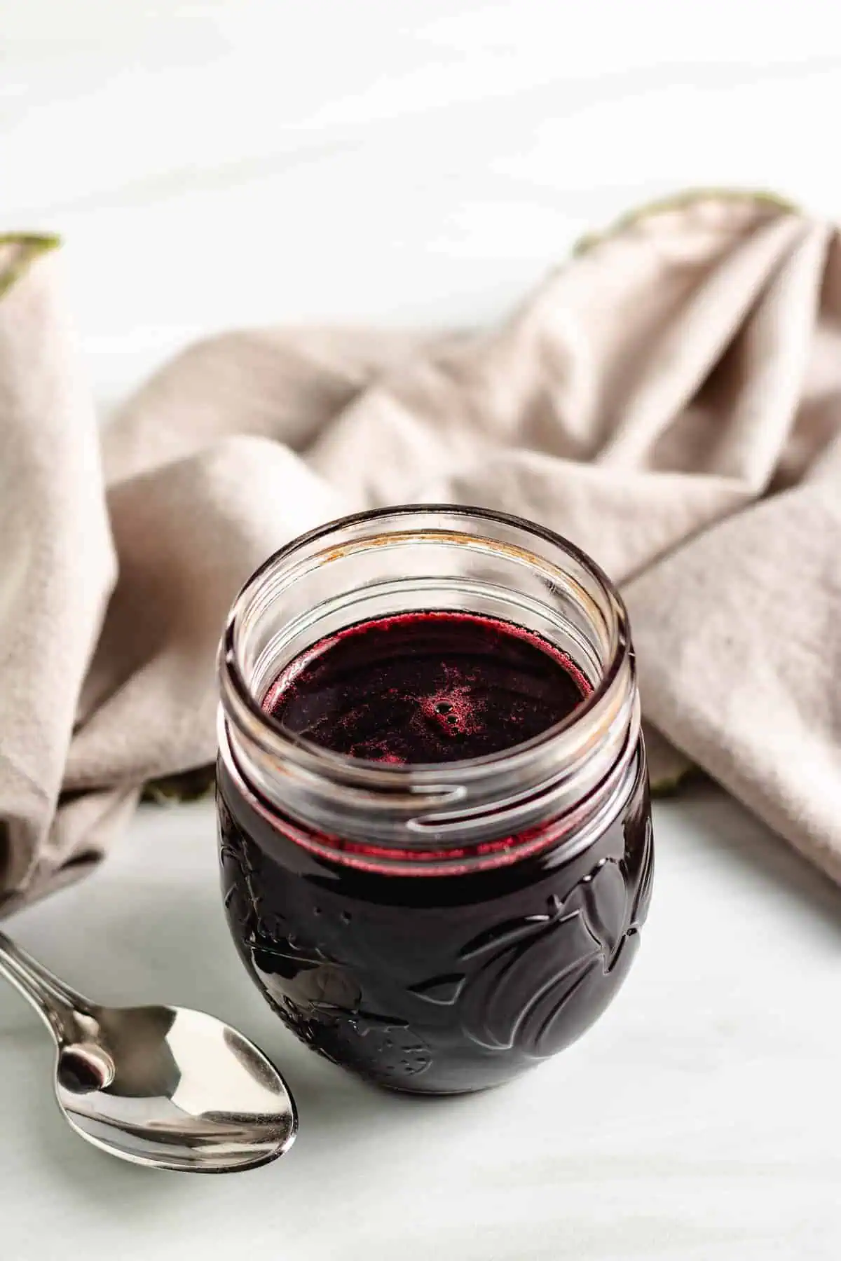 Blackberry syrup in a mason jar.