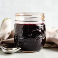 Mason jar filled with blackberry syrup.