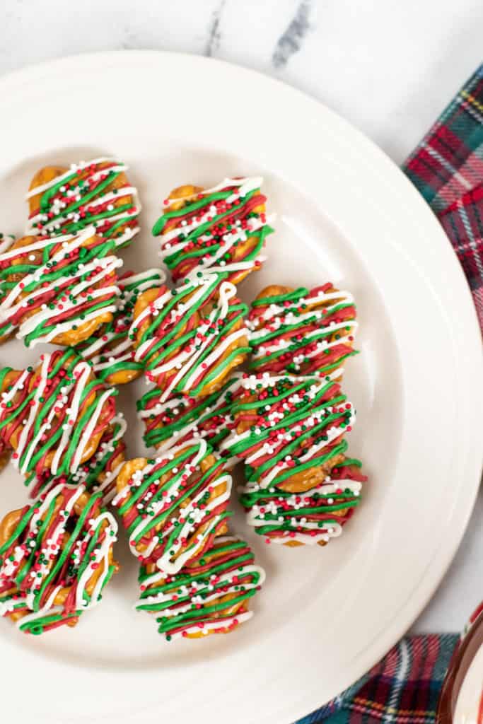 Top down view of a plate of chocolate drizzled pretzels.