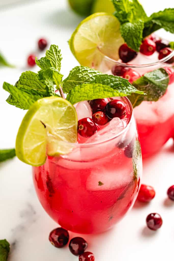 Top down view of cranberry mojitos with floating cranberries.