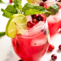 Close up view of two glasses of cranberry mojito.