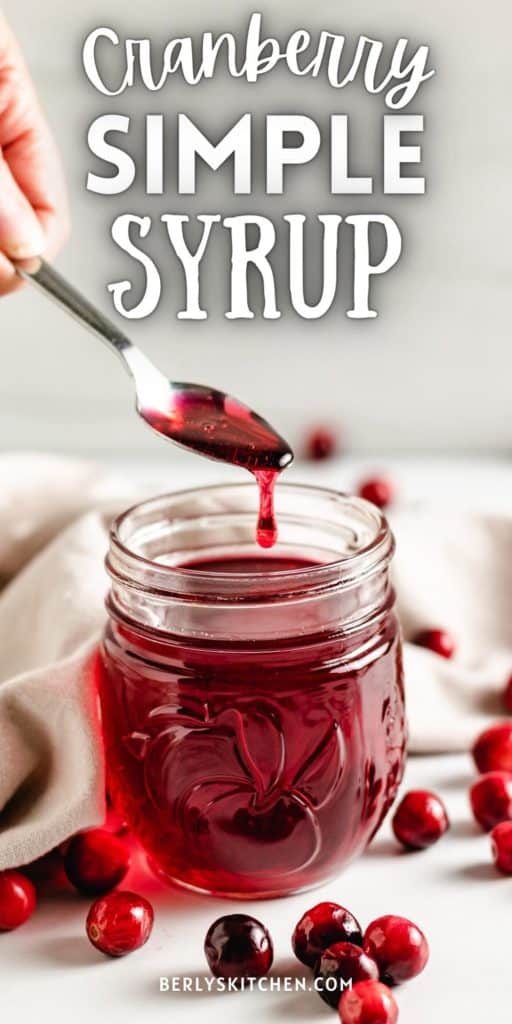 Cranberry simple syrup on a spoon.