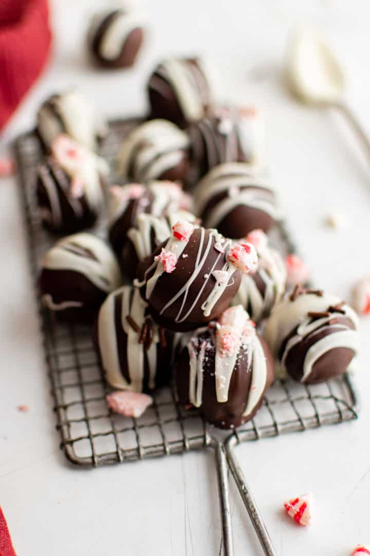 Wire cooling rack piled with peppermint truffles.