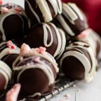 Peppermint truffles stacked on a wire rack.