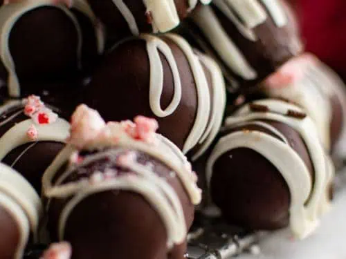 Peppermint truffles stacked on a wire rack.