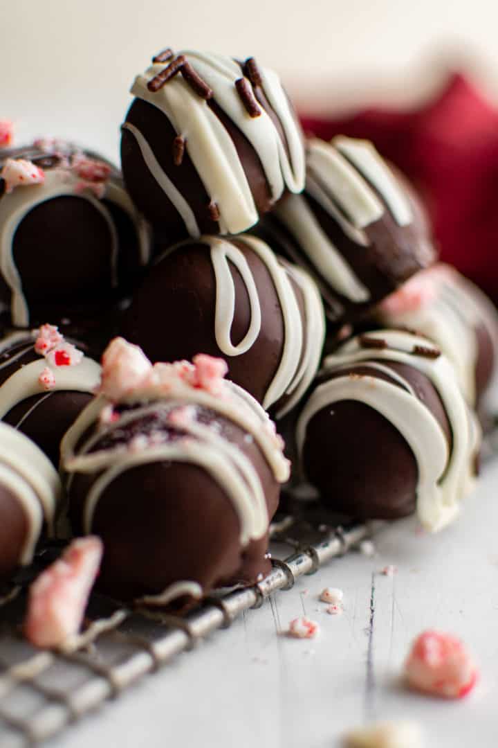 Peppermint truffles stacked on a wire rack.