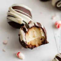 Close up of peppermint truffles and one with a bite taken out.