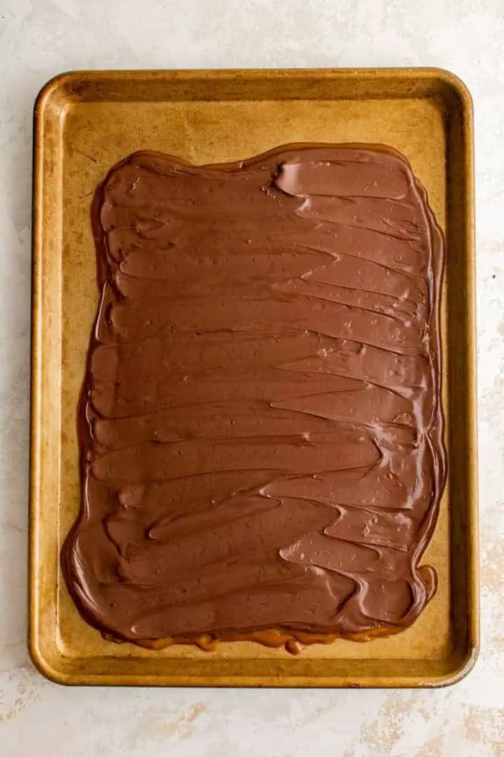 Melted chocolate spread over cooled toffee.