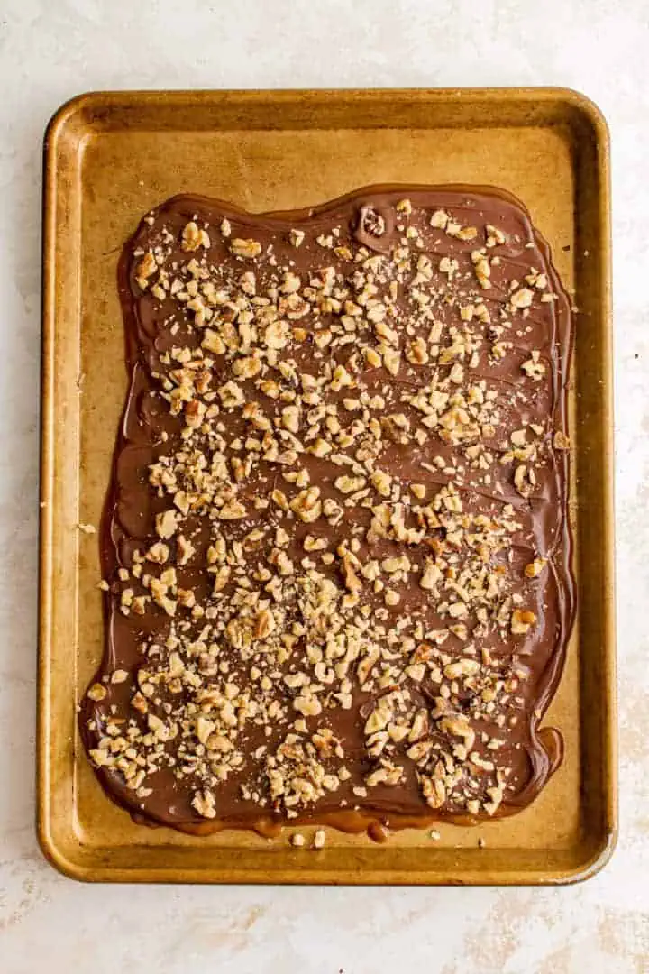 Nuts sprinkled over warm english toffe.