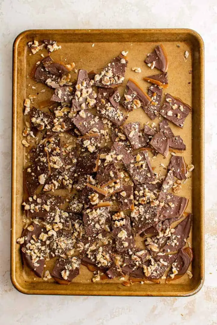 English toffee on a gold baking sheet.