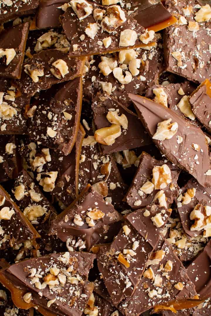 Close up view of toffee with chocolate and walnut pieces.