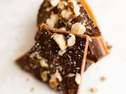 Close up view of pieces of toffee with nuts.