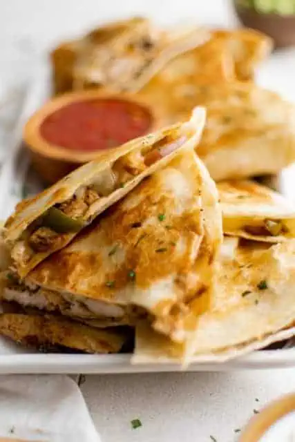 Fajita quesadilla piled on a plate.