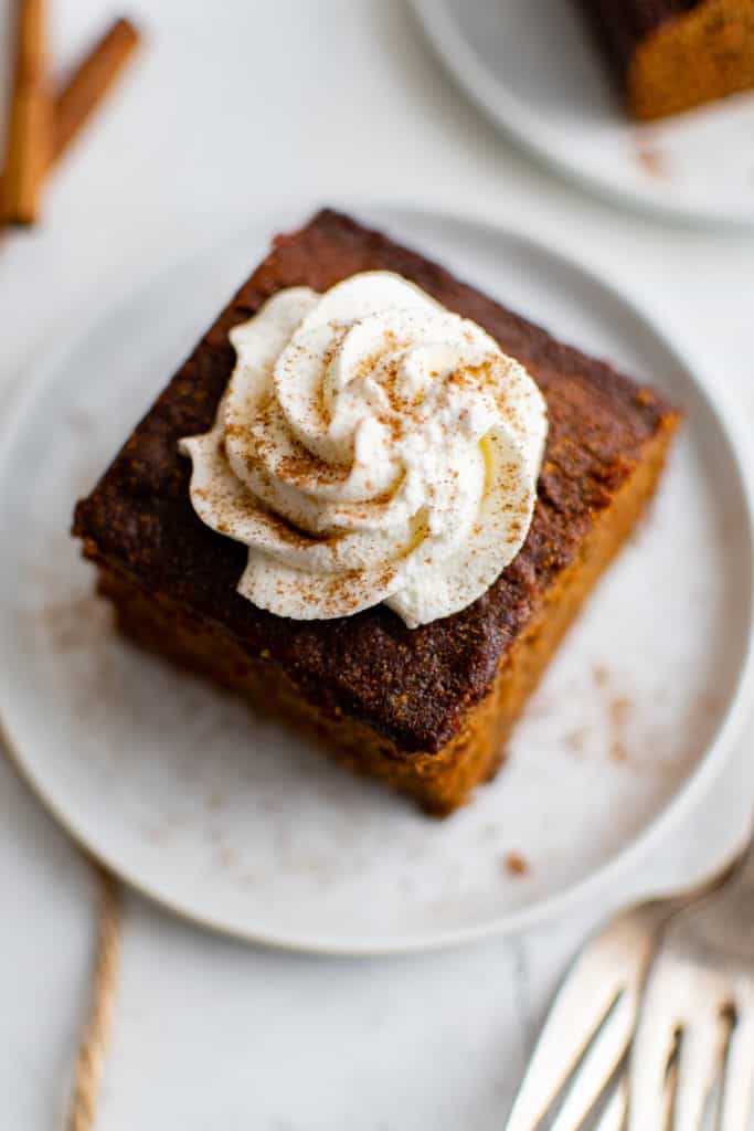 Top down view of gingerbread cake with whipped cream.