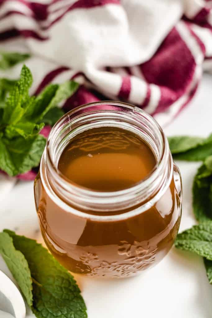 Small jar filled with mint simple syrup.