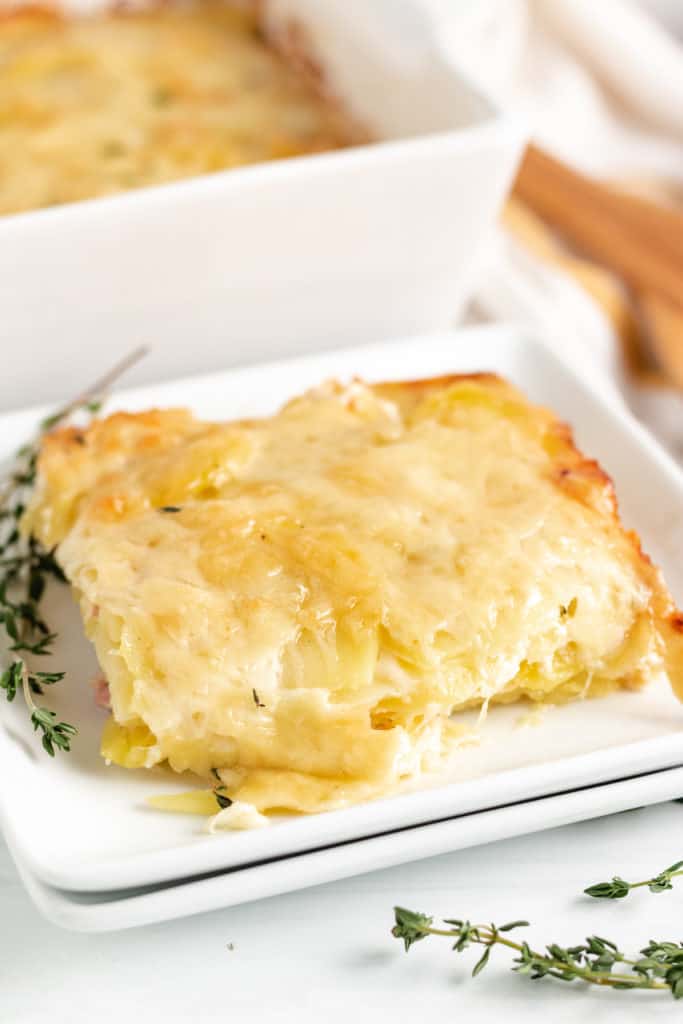 Scoop of potatoes au gratin on a serving plate.