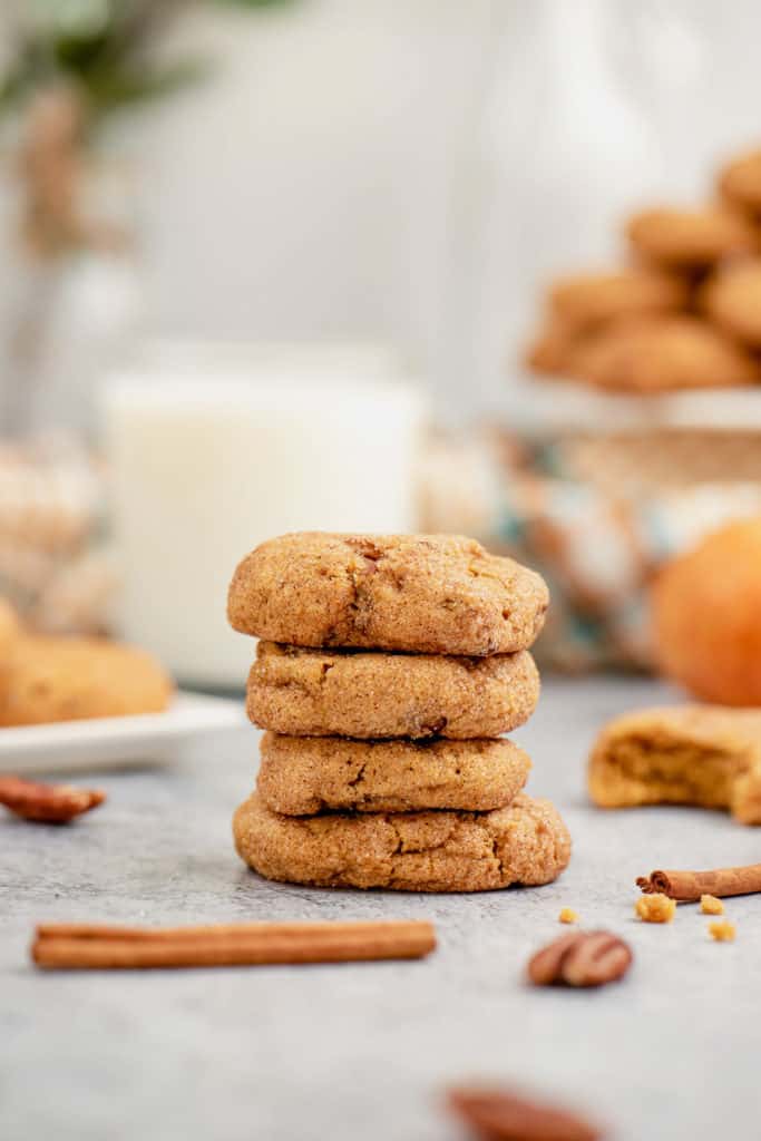 Stack of pumpkin snickerdoodles in front of milk.