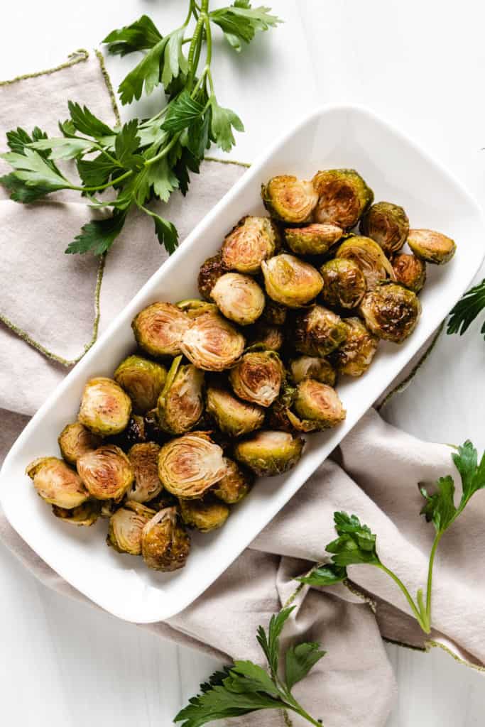 Top down view of roasted brussel sprouts on a platter.