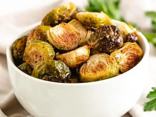 White serving dish filled with brussel sprouts.