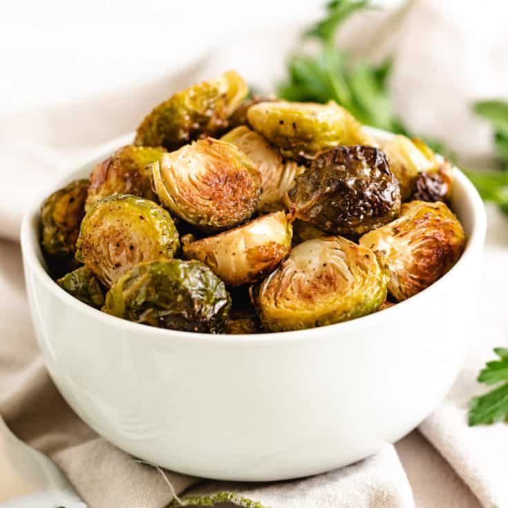 White serving dish filled with brussel sprouts.