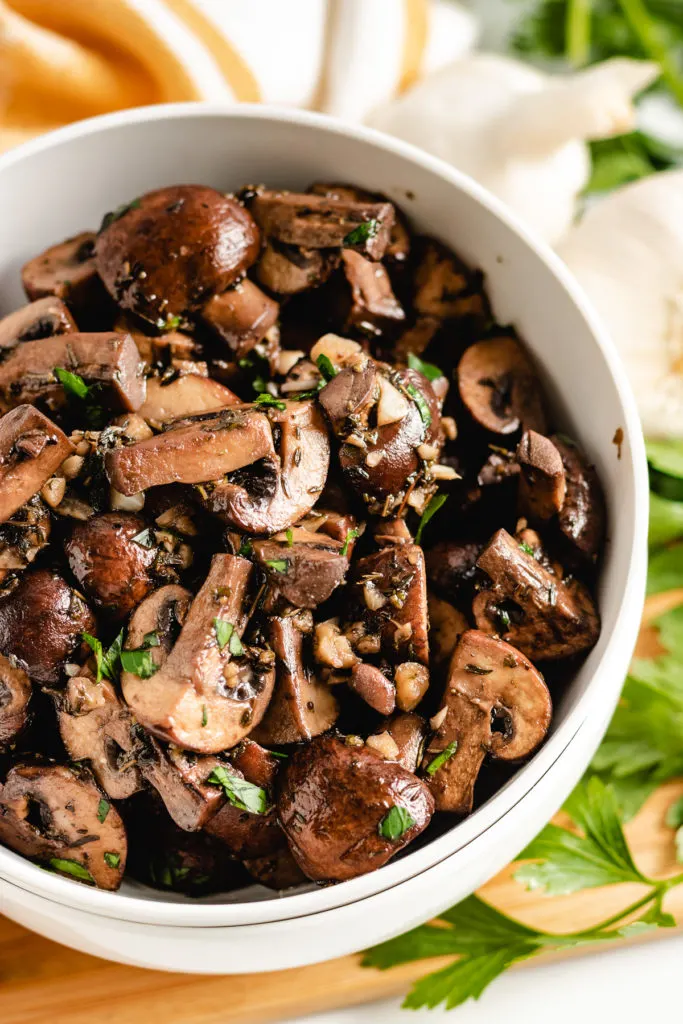 Top down view of sauteed mushrooms in a dish.