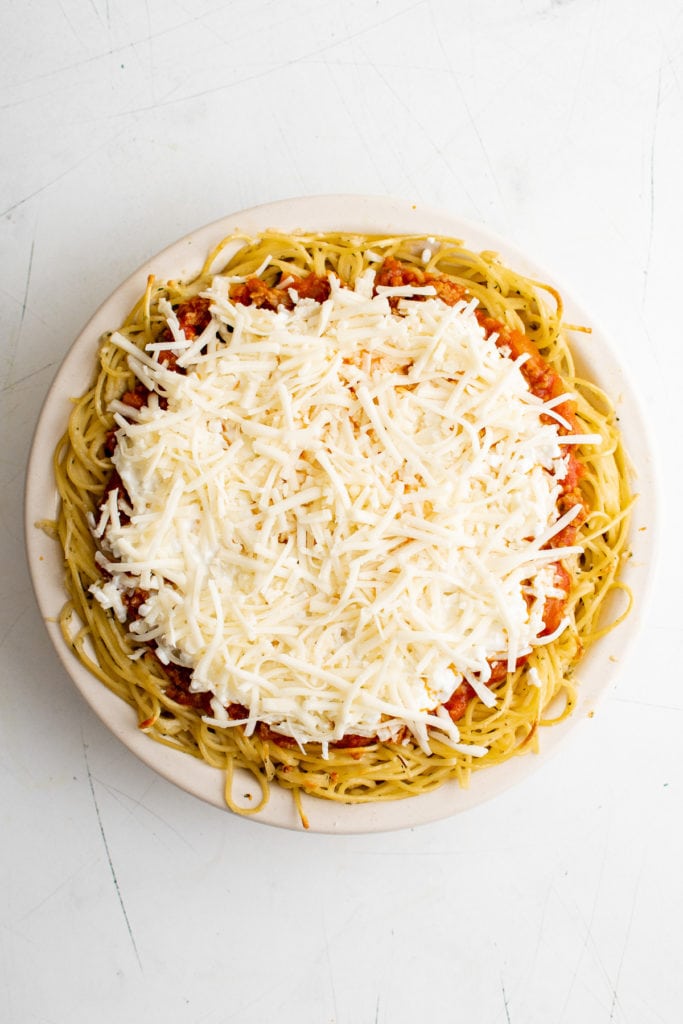 Top down view of mozzarella cheese on spaghetti bake.