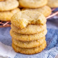 Stack of four sugar cookies with a blue linen.