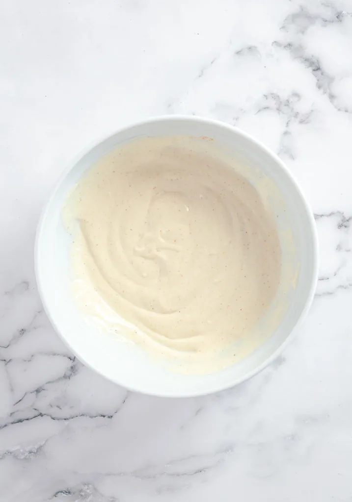 Bowl of dressing for pasta salad.