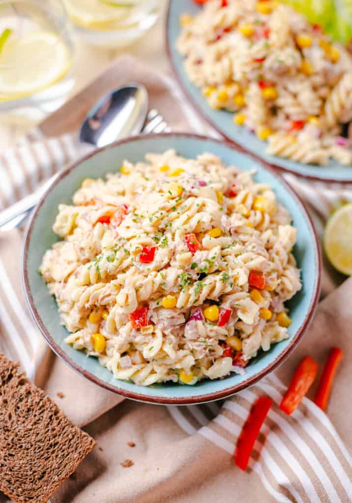 Blue plate filled with pasta salad.