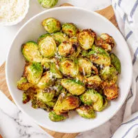 Light colored bowl filled with air fryer brussel sprouts.
