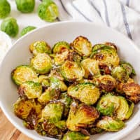 White bowl filled with caramelized brussel sprouts.
