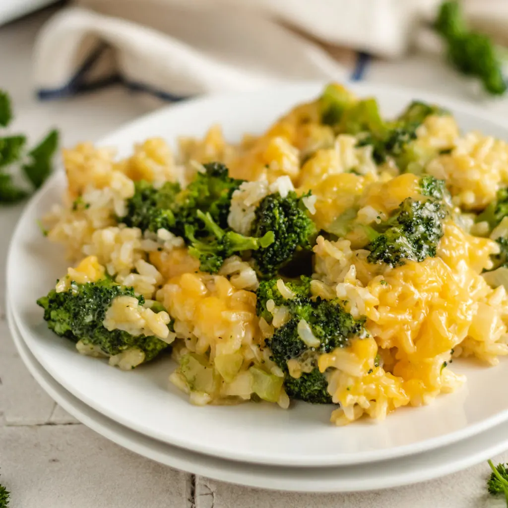 Broccoli rice casserole on two white plates.