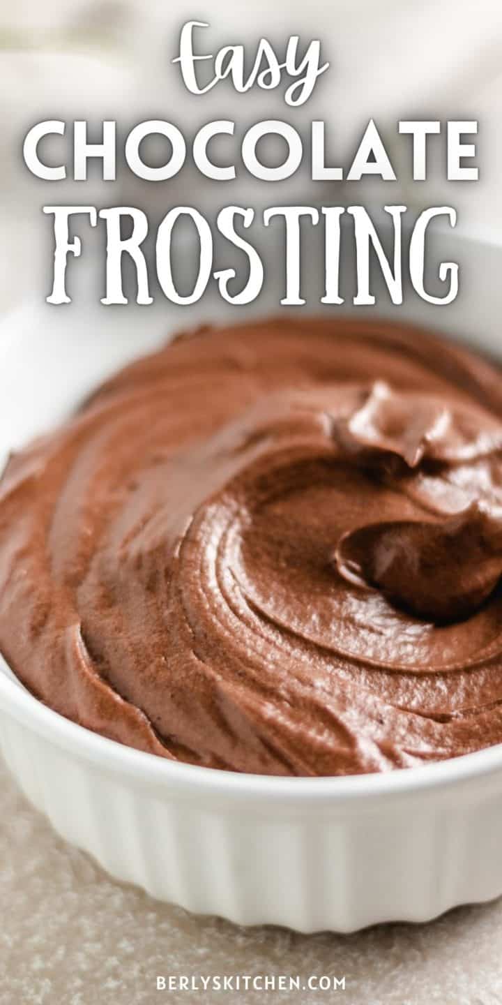 Close up view of chocolate frosting in a white bowl.