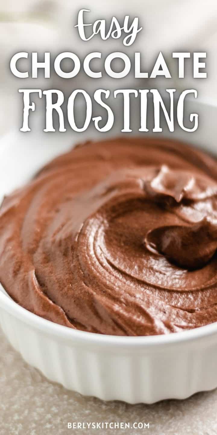 Close up view of chocolate frosting in a white bowl.